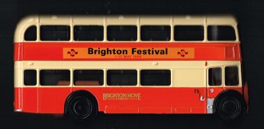 Diecast model bus, featuring an advert for the Brighton Festival's first year, 1968