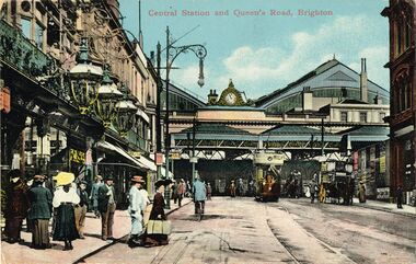 Queens Road approach to Brighton Station, before the demolition of the Terminus Hotel. The building on the hard left with the ornate lamps is the Queen's Head pub. Part of the Terminus Hotel sign can be seen in the background.