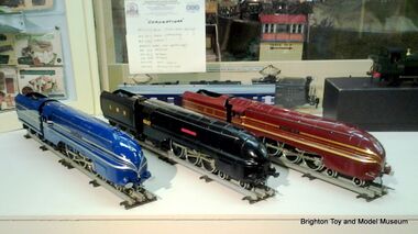 Streamlined Coronation Class locomotives 6220 Coronation (blue and silver), 6229 Duchess of Hamilton (red and gold), and 6247 City of Liverpool (in wartime black), modern gauge 0 models by ACE Trains
