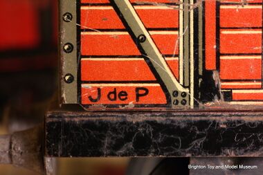Lithographed "JdeP" mark on the side of a tinplate wagon