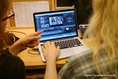 A volunteer being trained in the art of video editing
