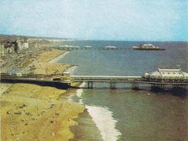 1965: Photograph of the West Pier (foreground) and Palace Pier (background), aerial view looking East