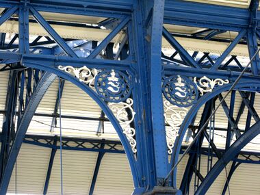Brighton Station, blue girderwork including roundels with the helmet and dolphins of Brighton's coat of arms