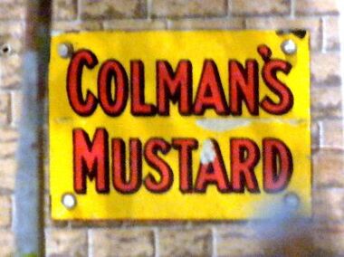 A tinplate Colman's Mustard poster, on the 1930s gauge 0 layout