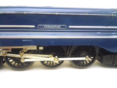 Hornby R.864 Coronation 6220 locomotive, side view. Note the flange removed on the centre pair of drivewheels, and the separate nameplate