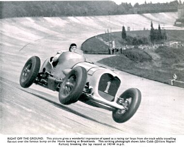 John Cobb (23-litre Napier-Railton) briefly airborne after the "Brooklands Bump", while breaking the lap record at 143.44 m.p.h. Redrawn versions of this iconic image were used in the promotional advertising for both Meccano Ltd.'s 1930s Motor Car Constructor sets, and the Märklin equivalent