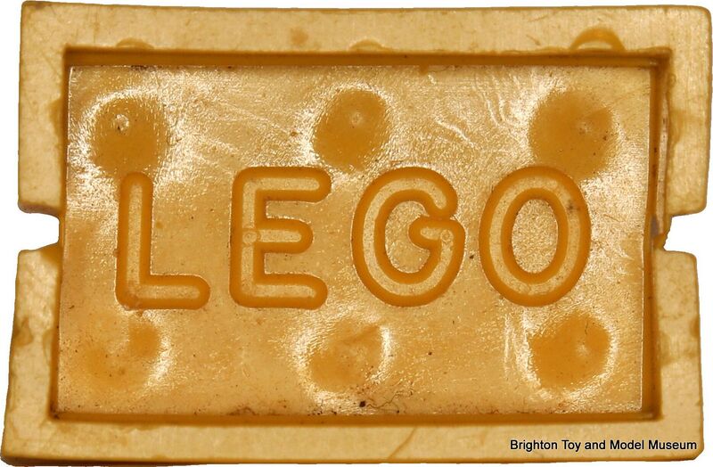 File:Lego Mursten slotted brick, underside, branded (Lego ~1953).jpg