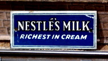Nestlé's Milk, blue and white miniature tinplate poster, 1920s/1930s, Bassett-Lowke Ltd.