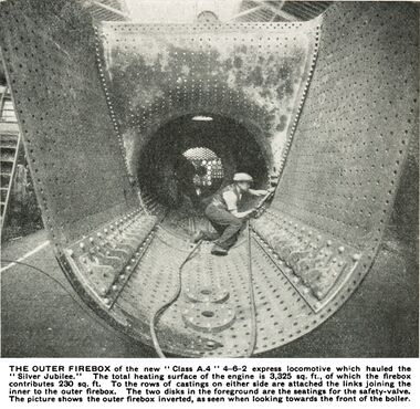 caption: THE OUTER FIREBOX of the new " Class A.4 " 4-6-2 express locomotive which hauled the Jubilee." The total heating surface of the engine is 3,325 sq. ft., of which the firebox contributes 230 sq. ft. To the rows of castings on either side are attached the links joining the inner to the outer firebox. The two disks in the foreground are the seatings for the safety-valve. The picture shows the outer firebox inverted, as seen when looking towards the front of the boiler.