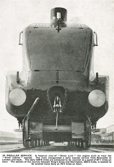 caption: IN REGULAR SERVICE. A head-on view of "Silver Link" the engine built to haul the "Silver Jubilee" express. The train inaugurated a daily express service from Newcastle to London and back. The daily 536.6 miles are scheduled to be covered at a speed of 67.1 miles an hour. The section of the journey between King's Cross and Darlington, 232.3 miles, is booked to be covered twice daily at 70.4 miles an hour.