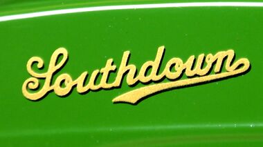 A slightly thick version of the "Mackenzie script" version of the Southdown logo, on the side of a small model Southdown coach